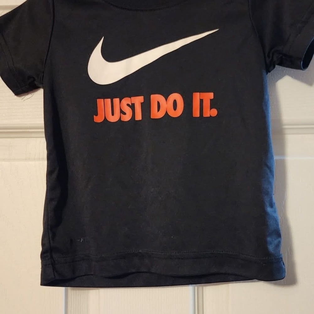 Nike Kids Black Tee with White Swoosh and Orange Text
